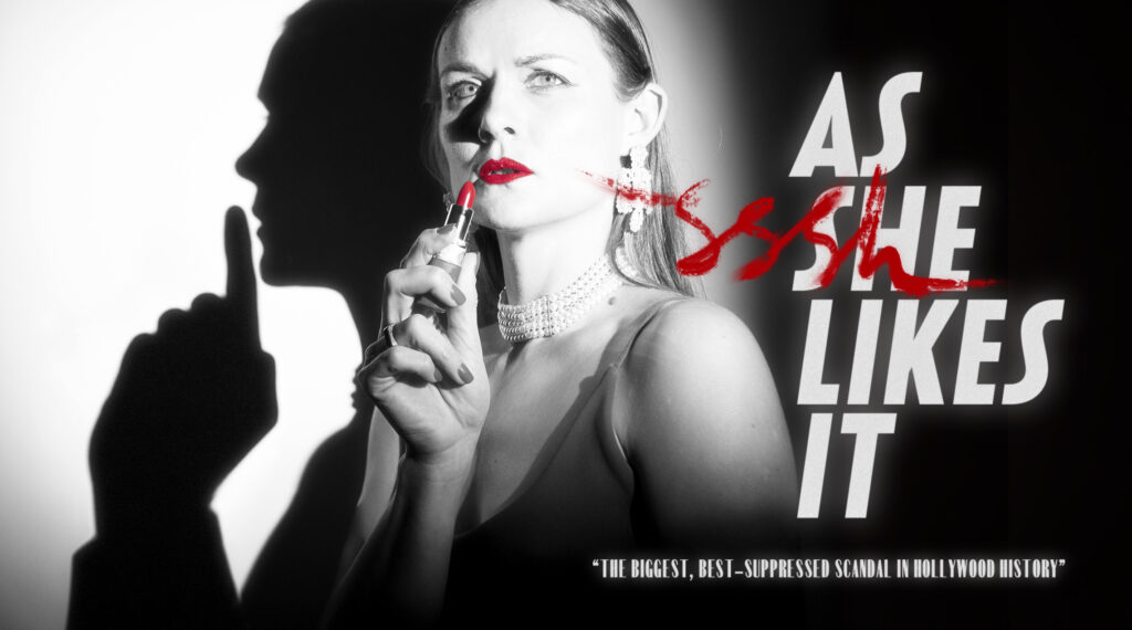A woman looks up into the light, red lipstick smears across her lips. An advertisement for the play As SHE Likes it, in black and white.